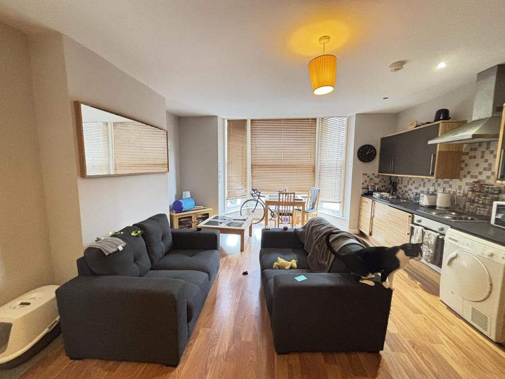 A spacious, modern living room featuring comfor...