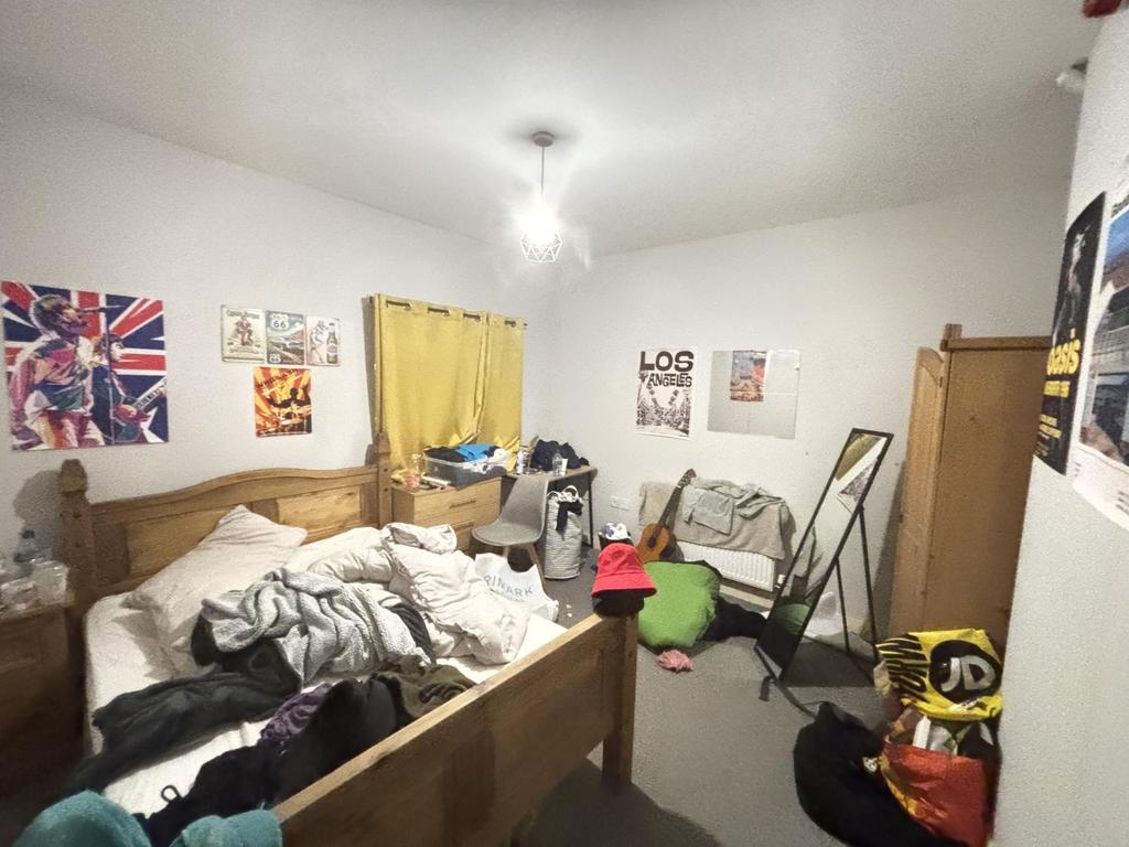A cozy bedroom with a double bed, showing a com...