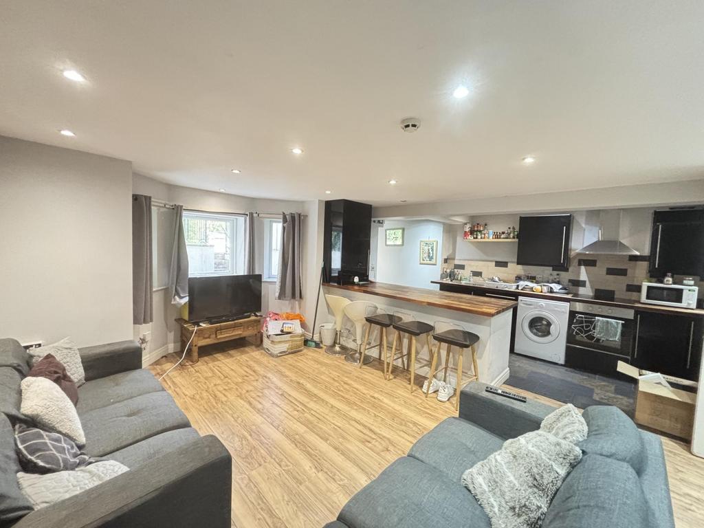 Bright and spacious living room featuring large...