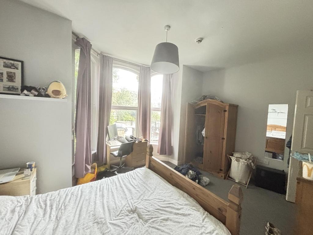 A cozy bedroom with a double bed, featuring a l...