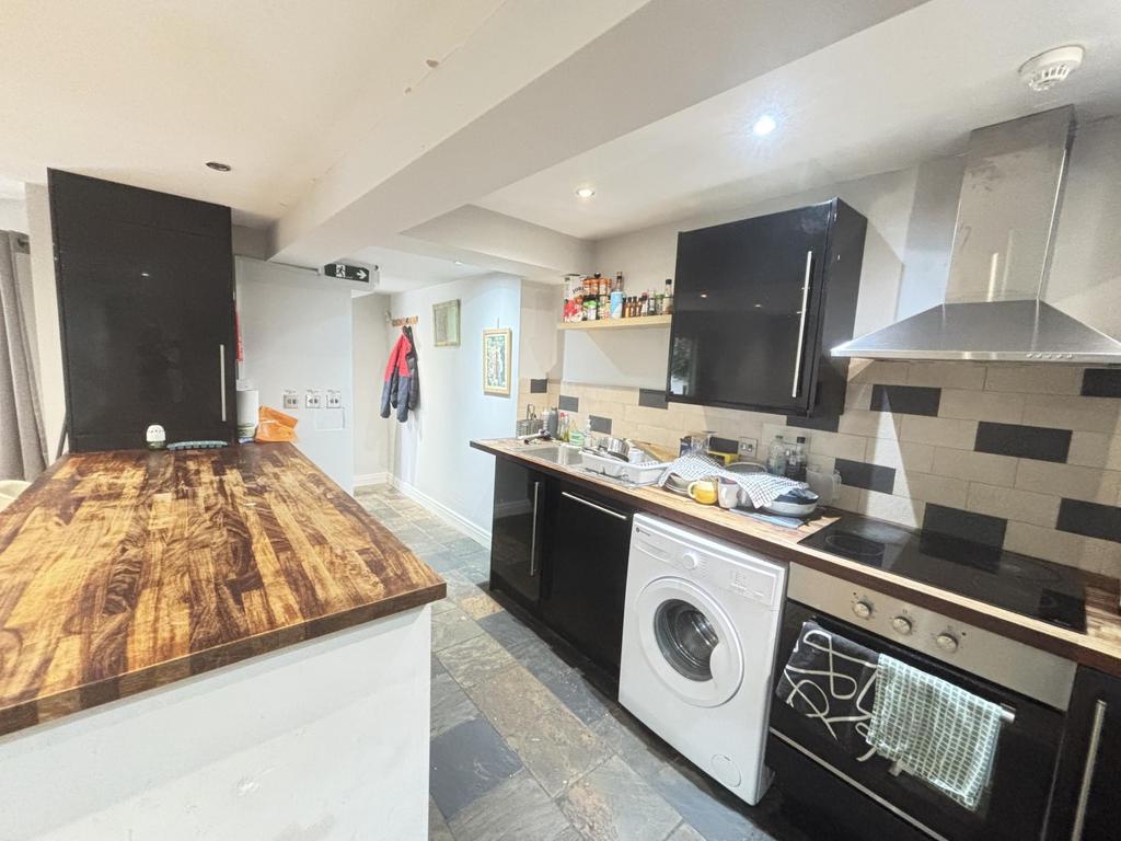 Modern kitchen featuring a wooden countertop, w...