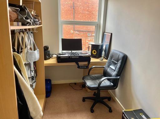 A functional student workspace featuring a desk...