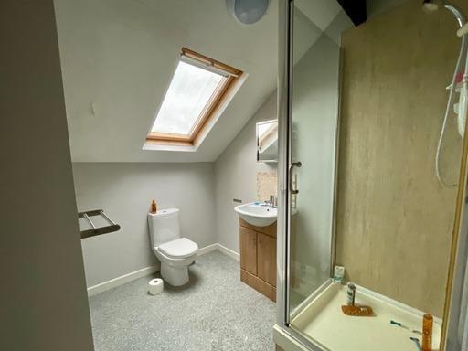 Bright and clean bathroom with natural light co...