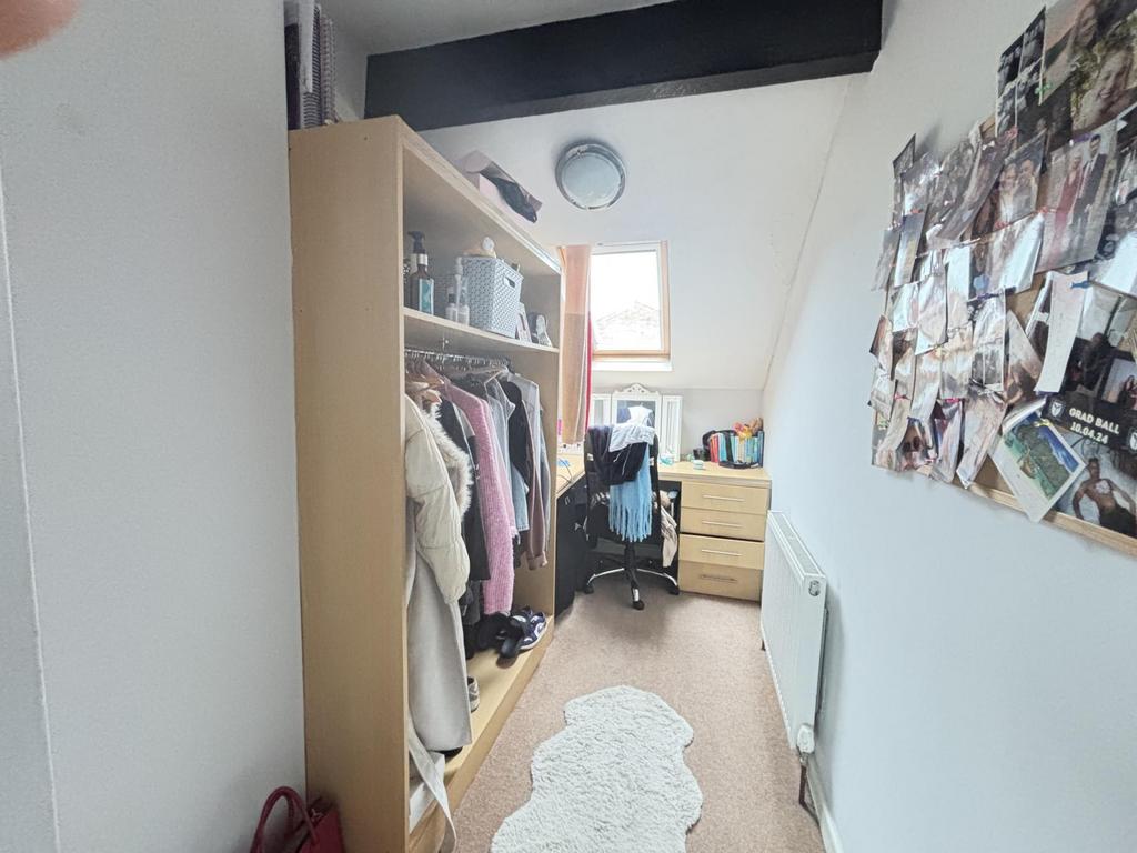 A bright and well-organized bedroom featuring a...