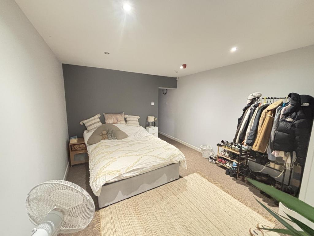 A bright, inviting double bedroom featuring a c...