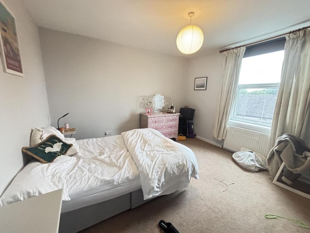 A spacious and bright master bedroom featuring ...