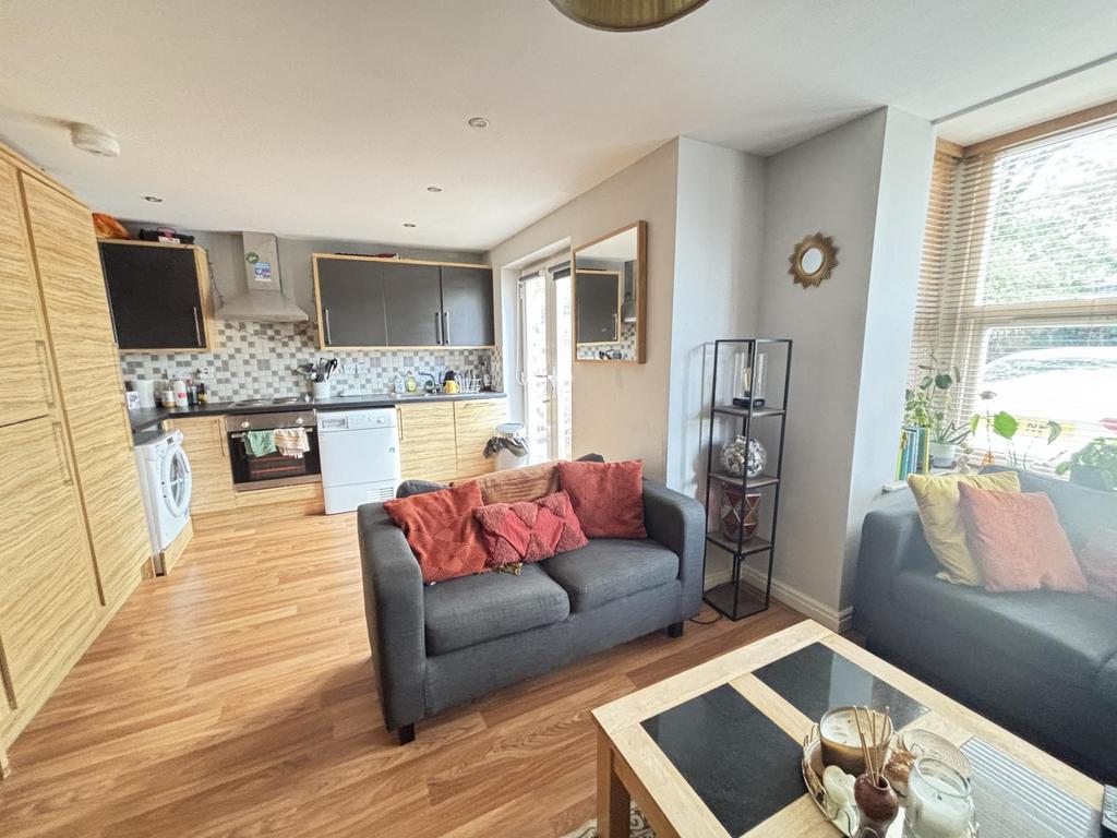 A bright and welcoming living room with ample n...