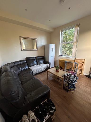 A well-lit and inviting living room featuring a...