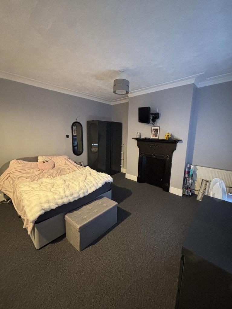A spacious master bedroom featuring a large dou...