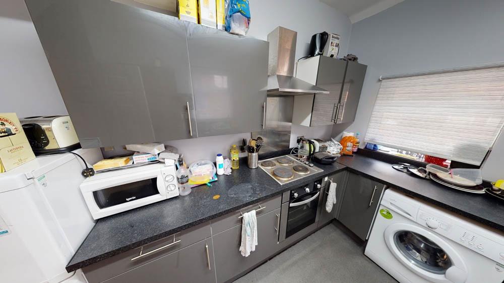 Modern kitchen space featuring appliances, coun...