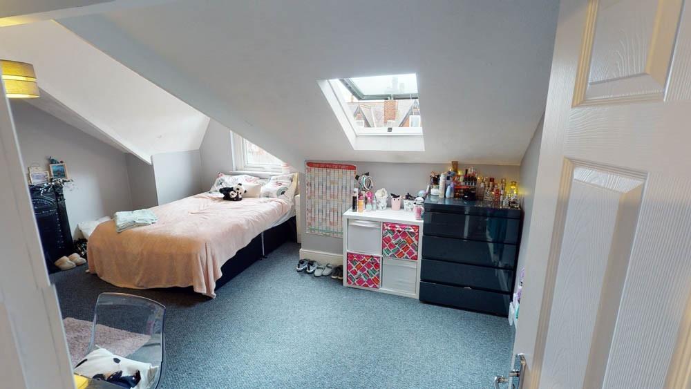 A cozy and well-maintained bedroom with a comfo...