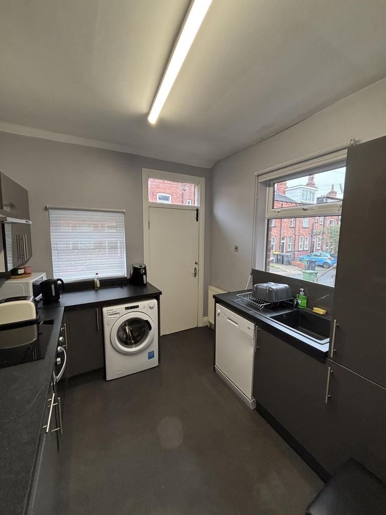 A modern kitchen space featuring ample natural ...
