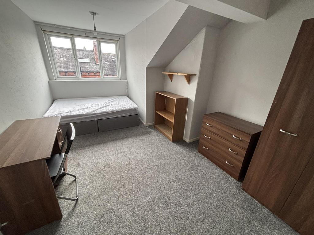 A cozy, well-maintained single bedroom with nat...