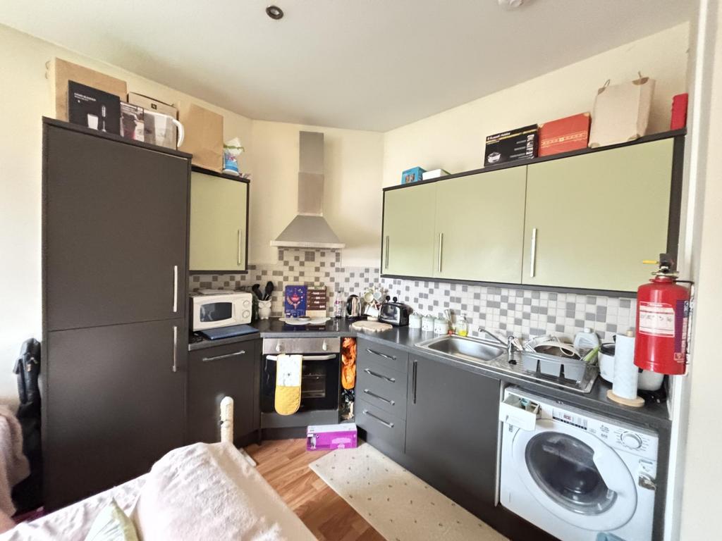 A modern kitchen area featuring a sleek grey an...