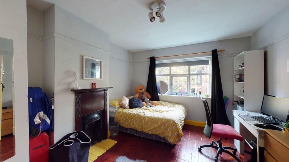 Spacious master bedroom featuring a large bed, ...