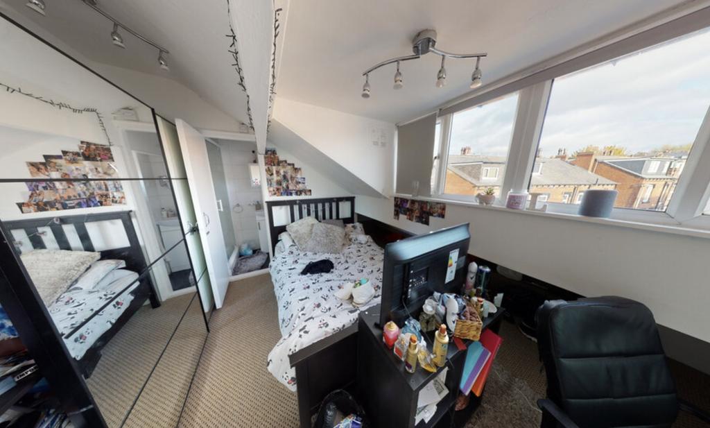 Bright and spacious living room with large wind...