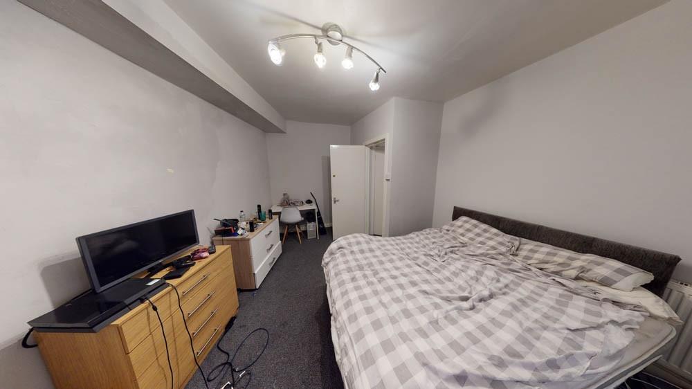 A cozy, well-maintained bedroom with a comforta...