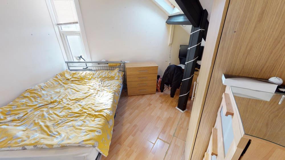 A cozy single bedroom with natural light coming...