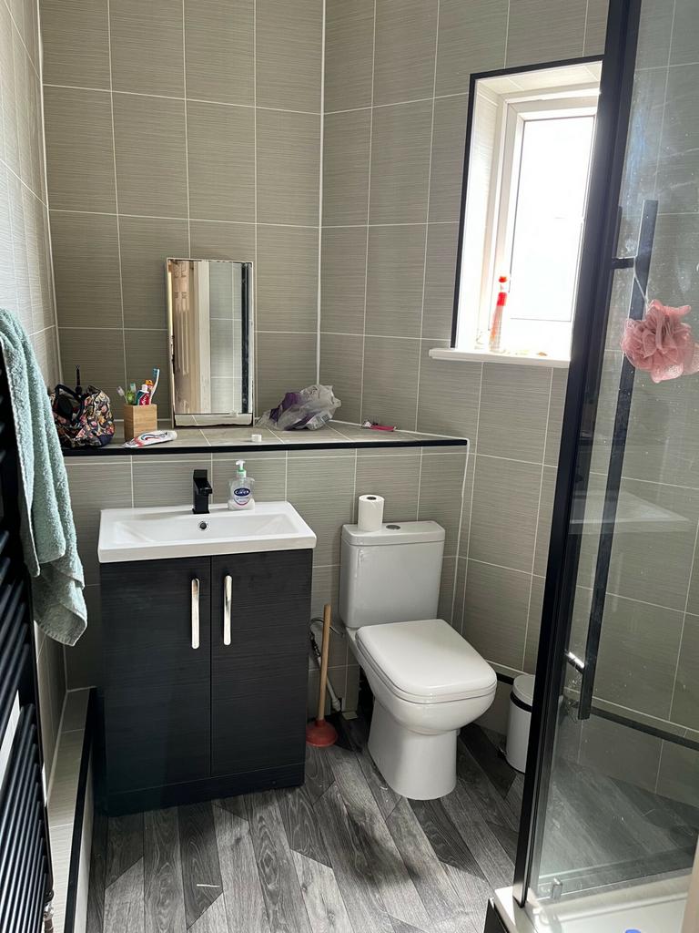 A modern and clean bathroom with a toilet, a sm...