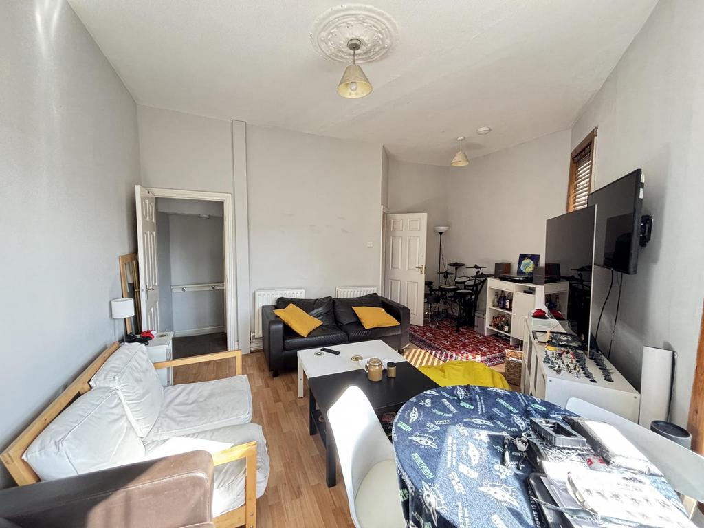 A spacious and welcoming living room with ample...
