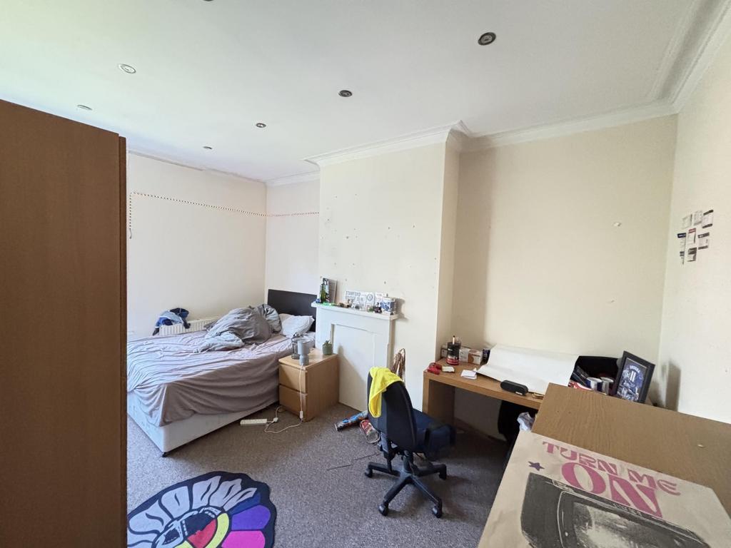 A comfortable bedroom featuring a single bed an...