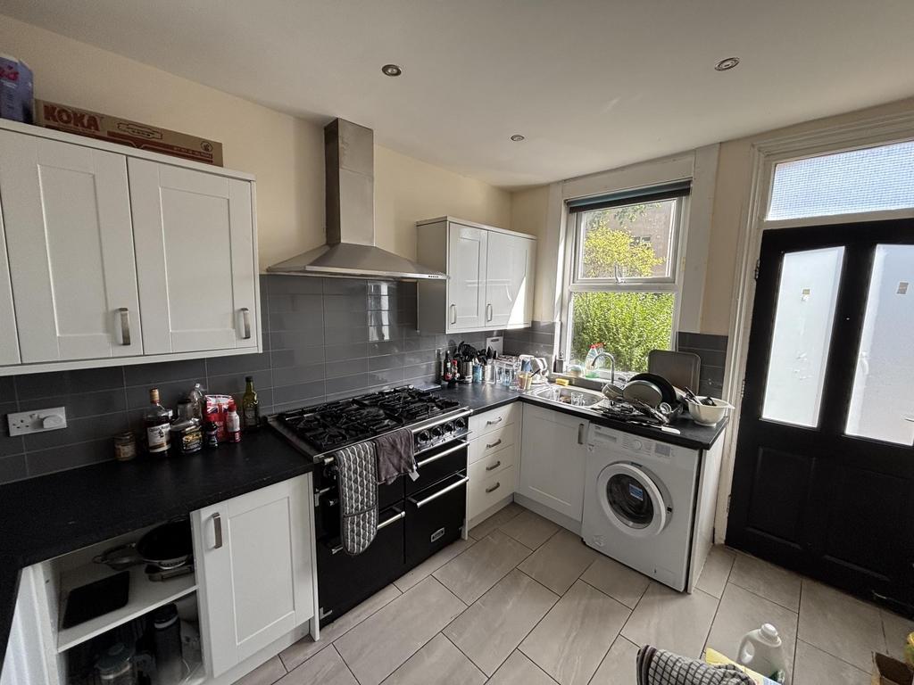 A modern kitchen featuring streamlined cabinetr...