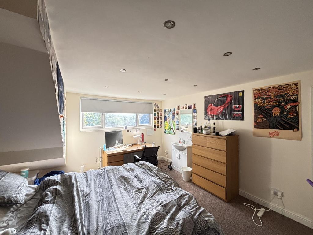 Bright and cozy bedroom featuring a large bed, ...