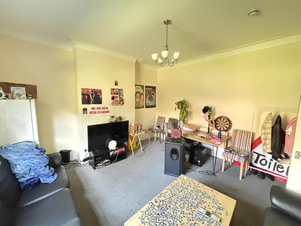 A welcoming and well-lit living room featuring ...