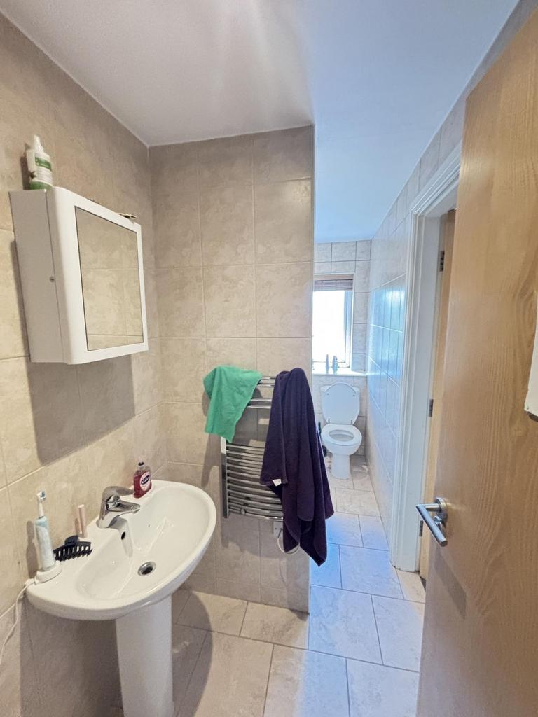 A spacious bathroom with a sink, mirror, and a ...
