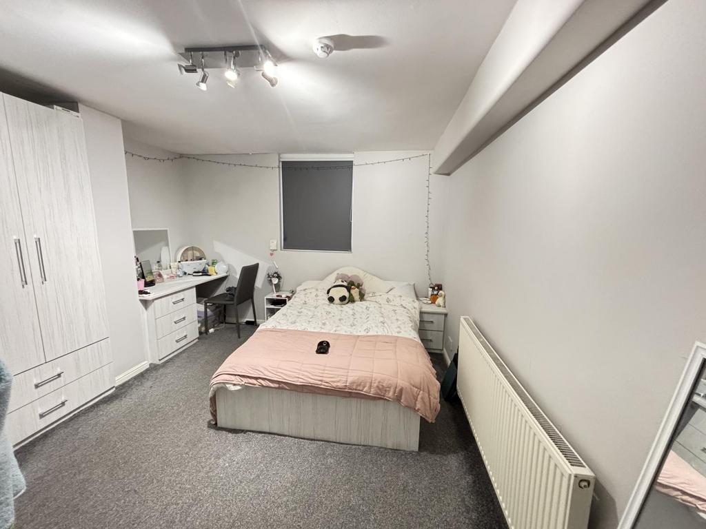 A bright and spacious master bedroom featuring ...