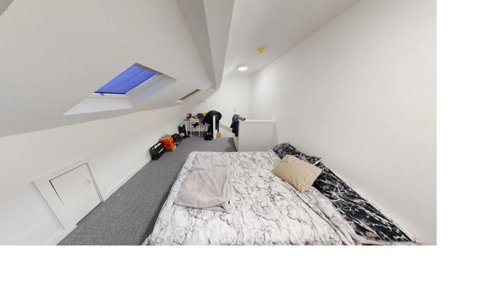 Bright and airy master bedroom with a comfortab...