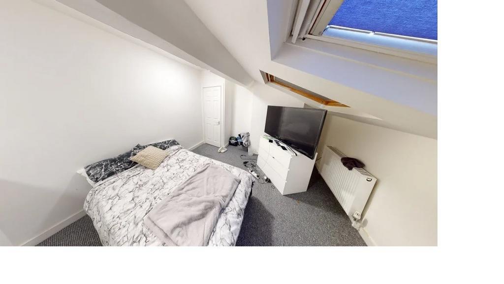 A bright and welcoming bedroom featuring a doub...