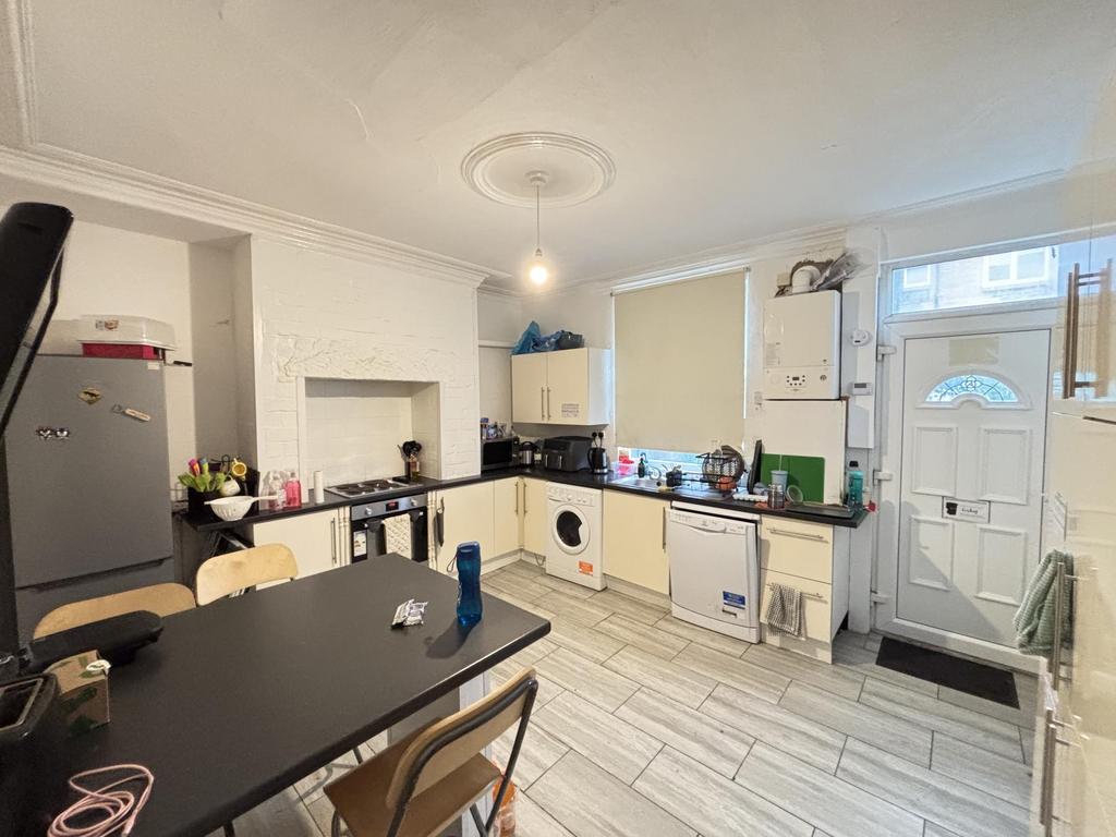 Bright and spacious kitchen area featuring larg...