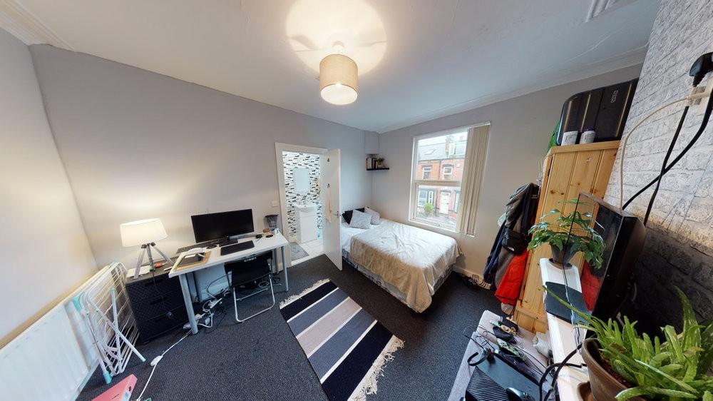 Bright and cozy bedroom featuring a double bed,...