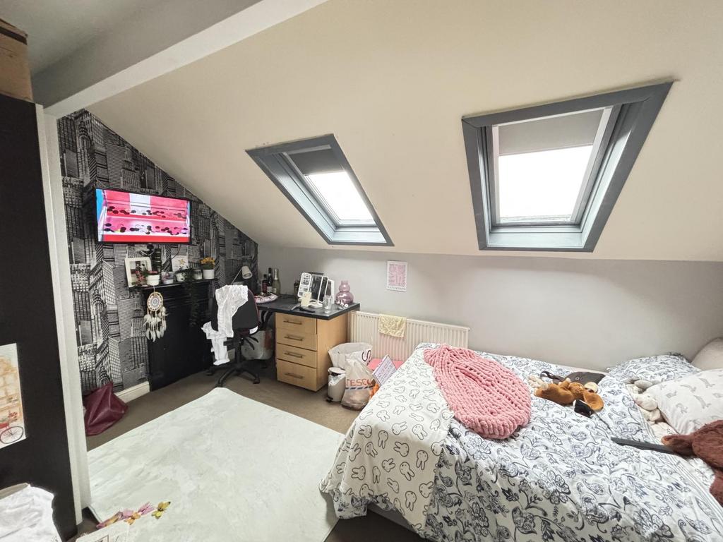 A bright and cozy bedroom featuring two neatly ...