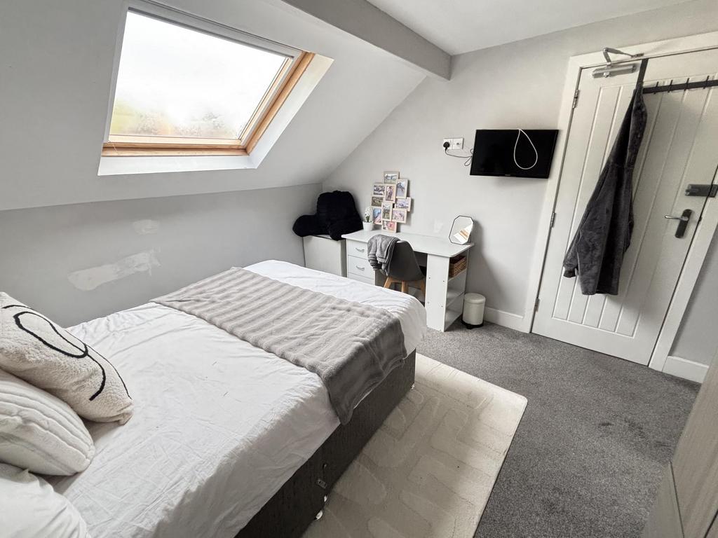 A bright and spacious master bedroom with a lar...