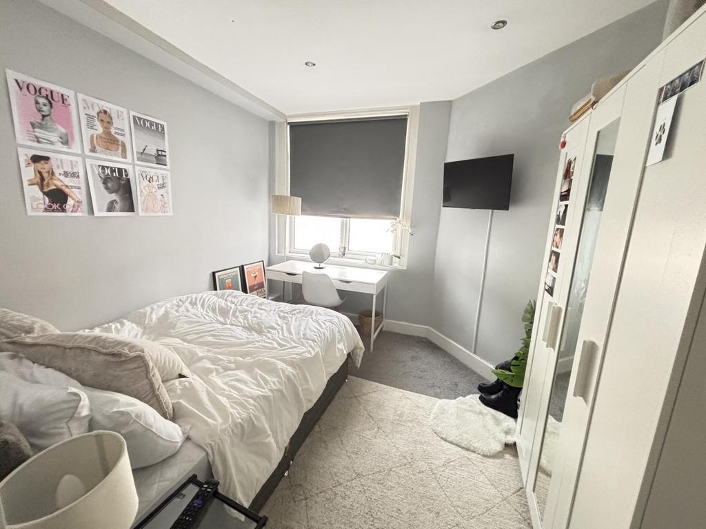 Bright and inviting bedroom featuring a double ...