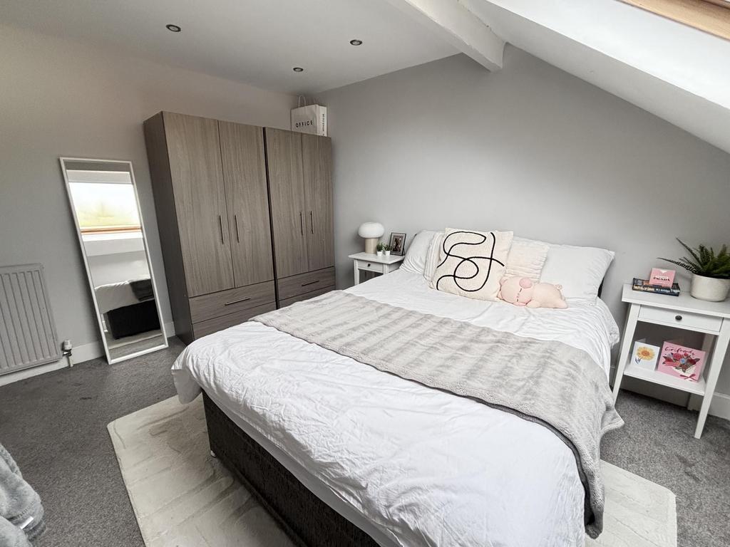 A bright and spacious master bedroom featuring ...
