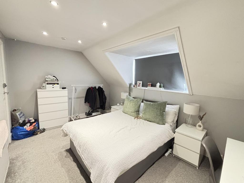 Bright and spacious master bedroom featuring a ...