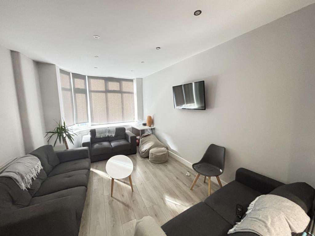 A spacious, well-lit living room with a contemp...