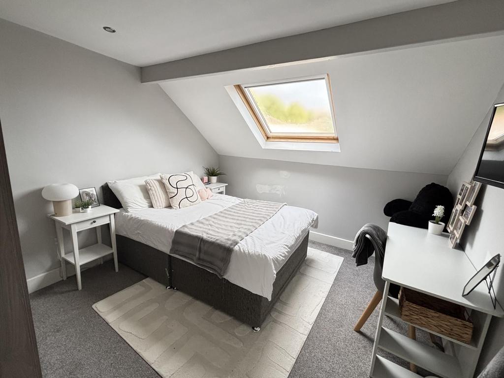 A bright and neatly maintained bedroom with a c...