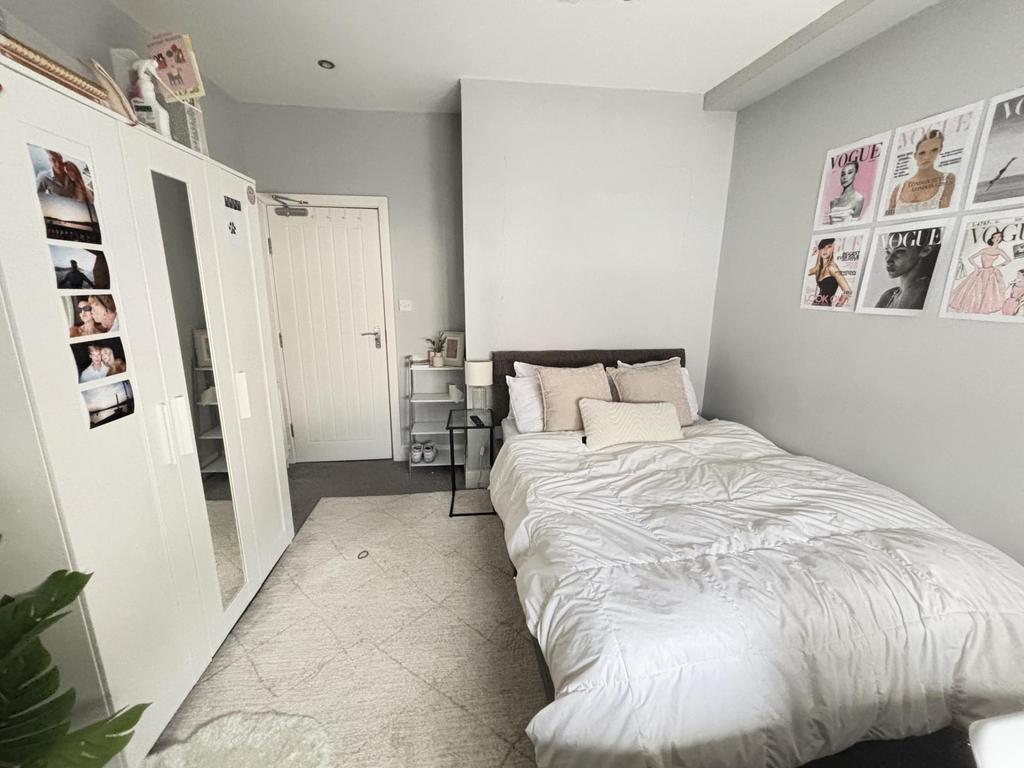 A bright and spacious master bedroom featuring ...