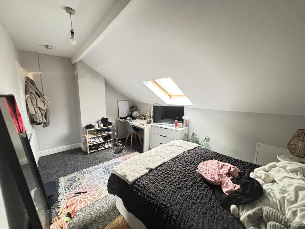 A cozy bedroom with a large double bed, natural...