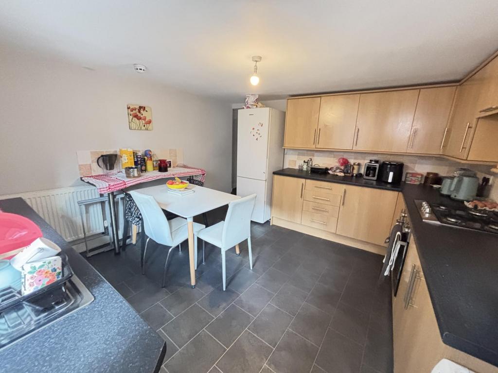 A bright and modern kitchen area with ample woo...