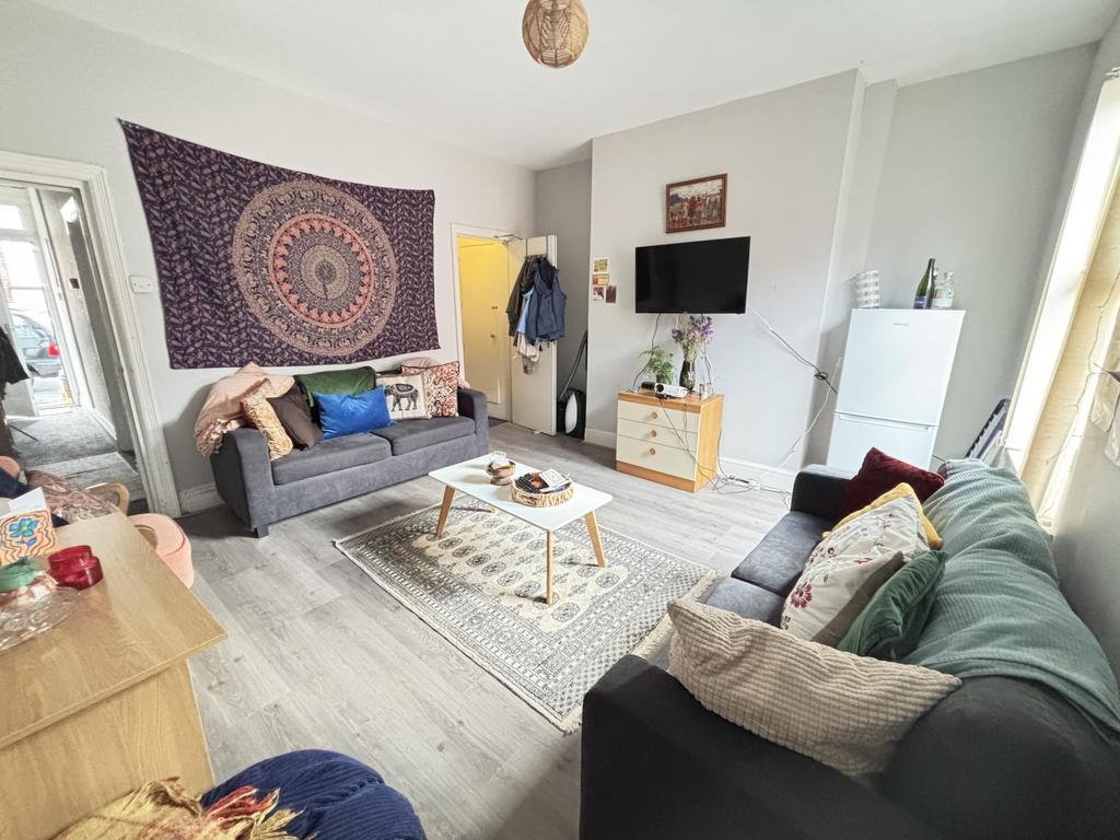 A welcoming, well-lit living room with modern f...