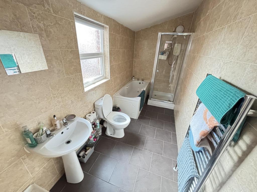 A well-maintained bathroom featuring a bathtub,...