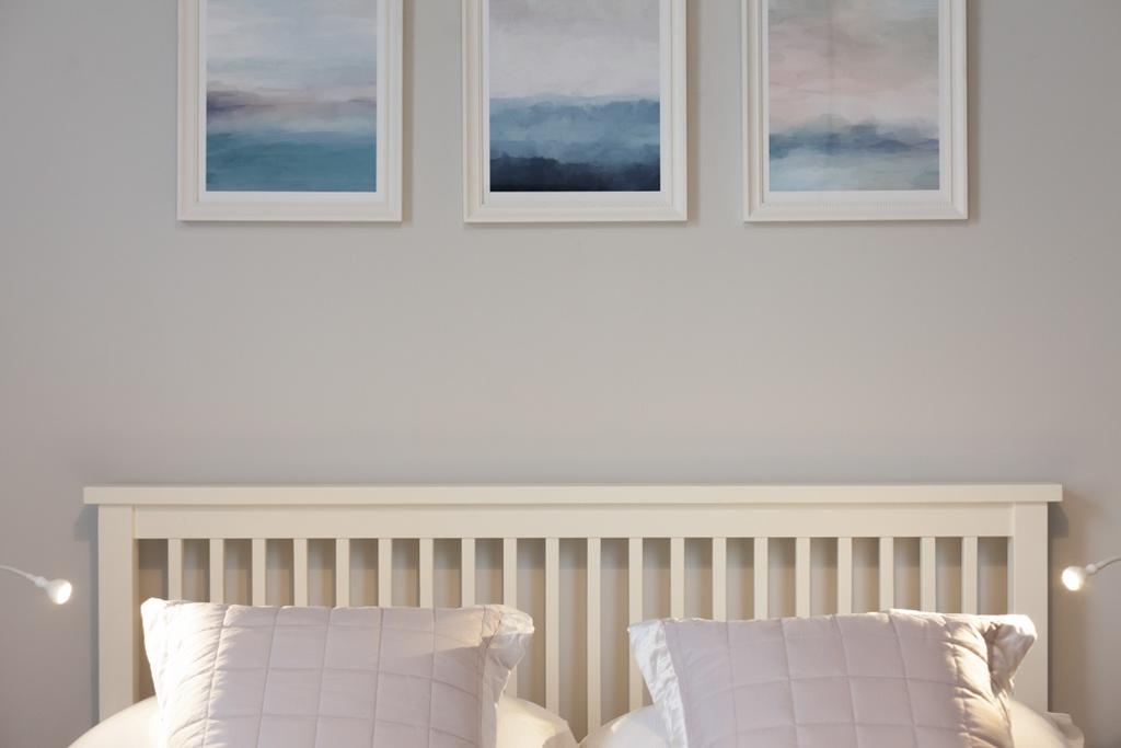 Bright, softly styled bedroom with a clean whit...