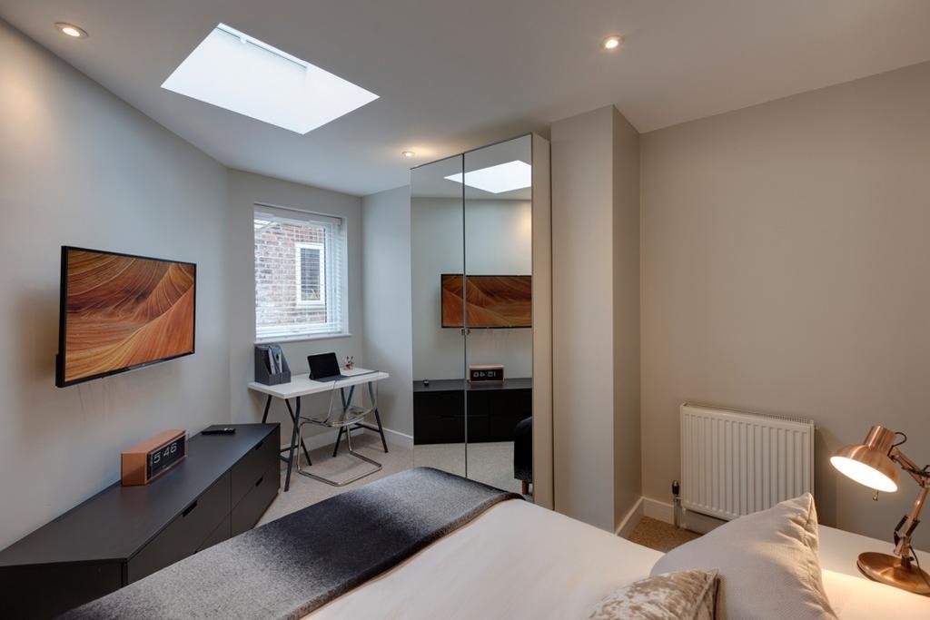 Bright, contemporary bedroom with a comfortable...