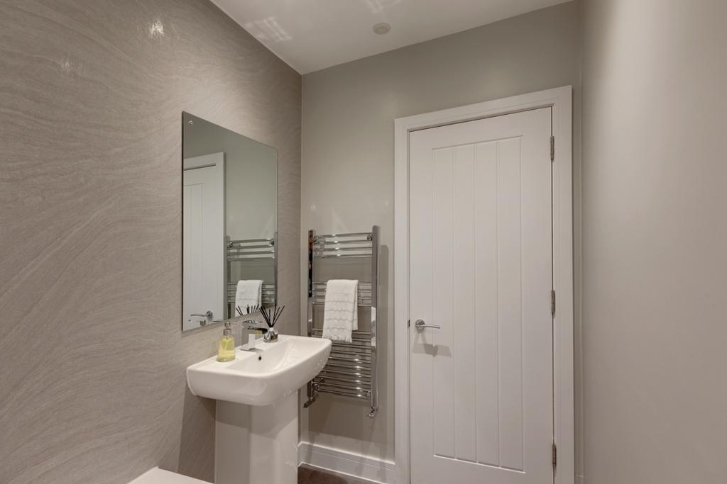 Contemporary bathroom with a pedestal sink, lar...