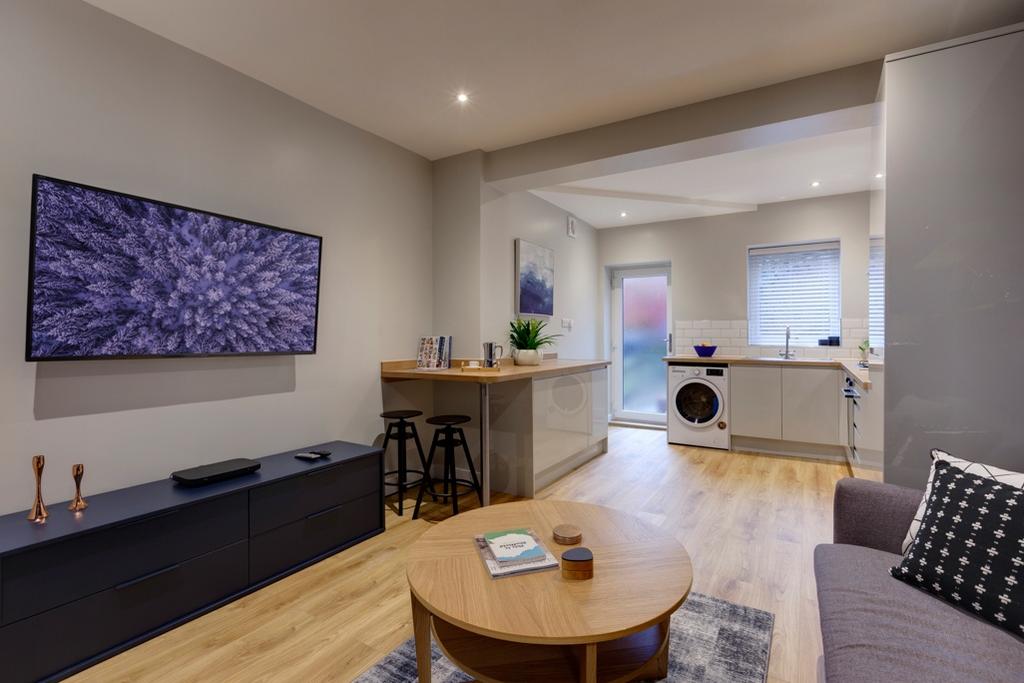 Bright open-plan living room with a wall-mounte...